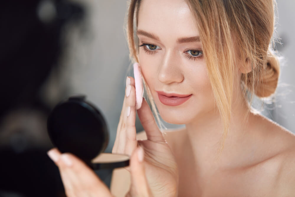 Woman applying foundation