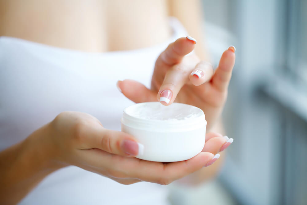 Woman holding face cream