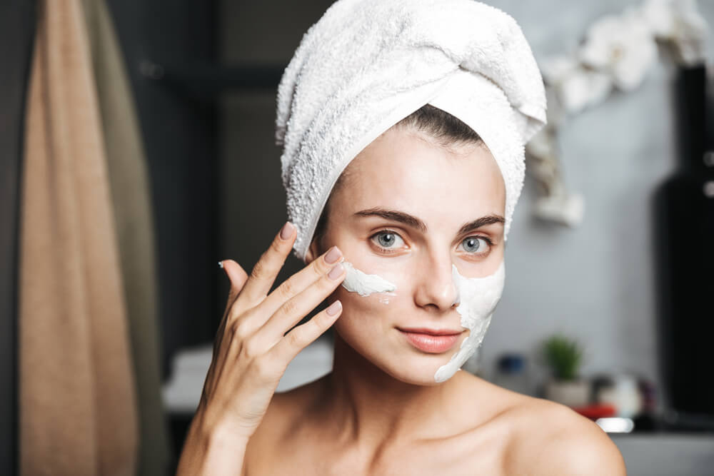 Woman applying face mask