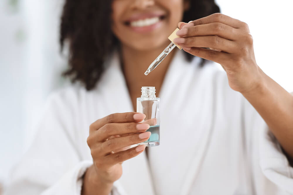 Woman with serum and dropper
