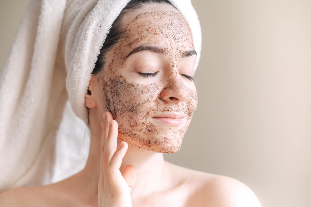 Woman using face scrub