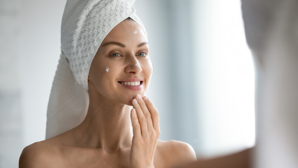 Woman applying face cream