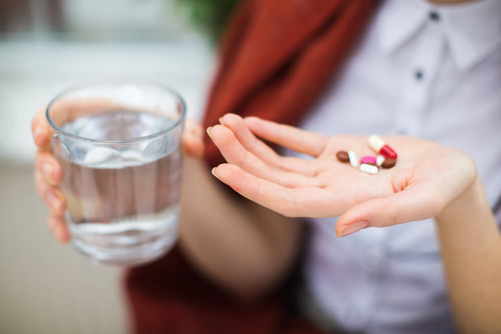 Woman holding pills