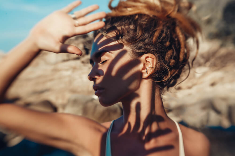 Woman shielding face from sun