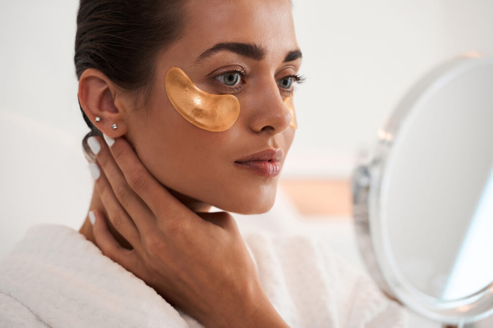 Woman using gold eye masks