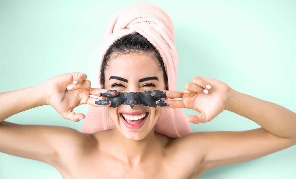 Woman applying face mask