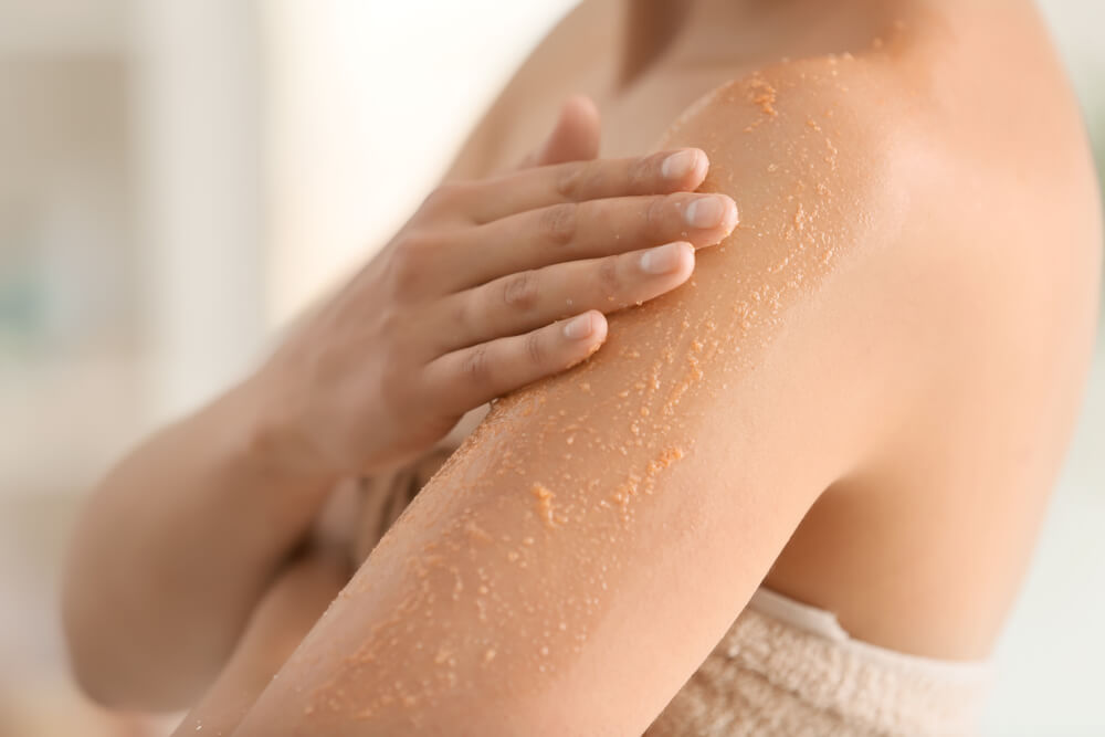 Woman using body scrub