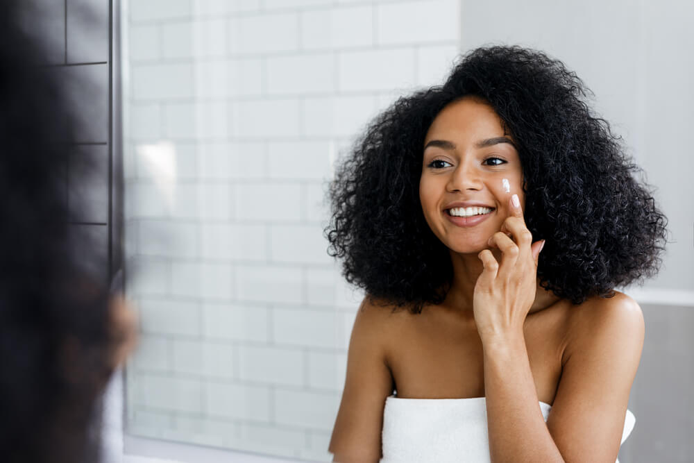 Woman applying face cream