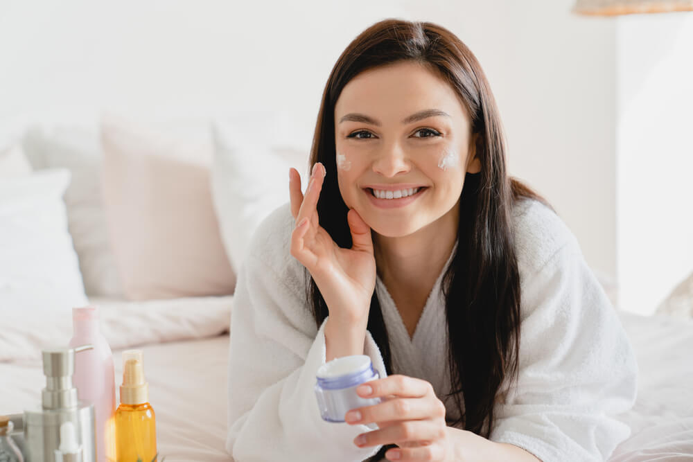 Woman applying face cream