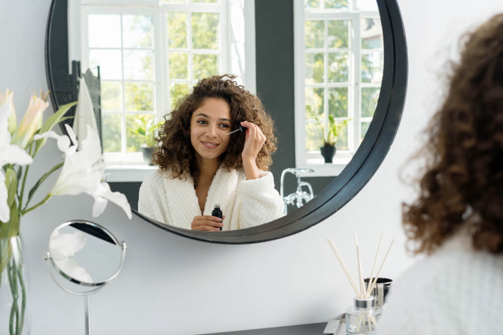 Woman applying eye serum