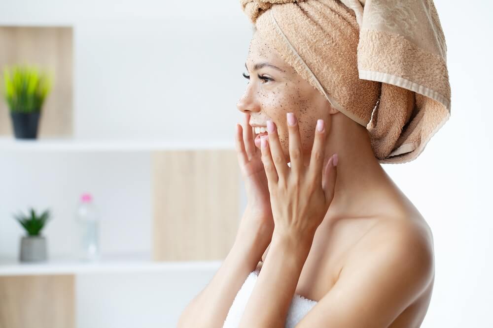 Woman using exfoliators on face