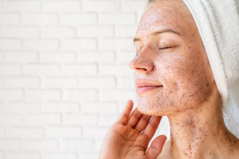 Woman using exfoliators