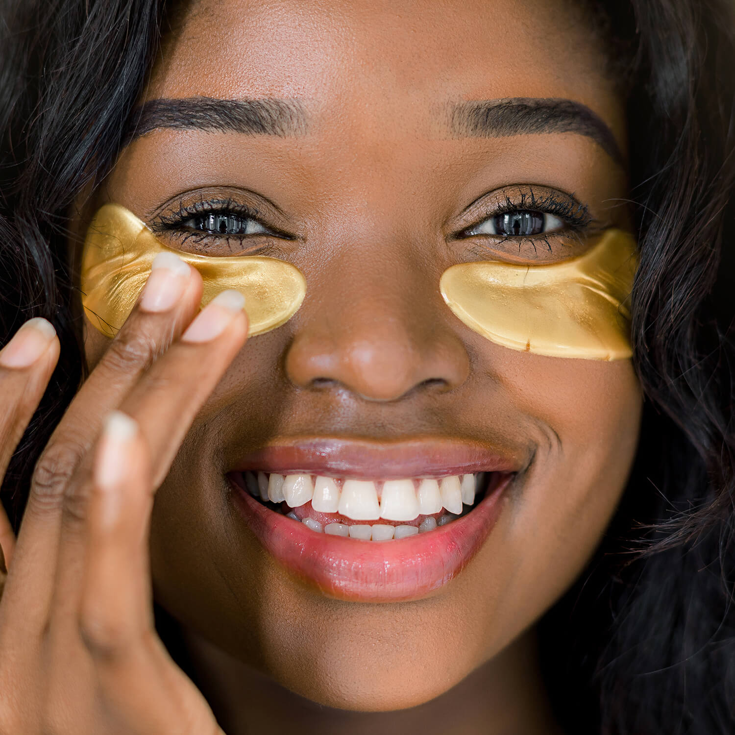 Woman using gold eye mask