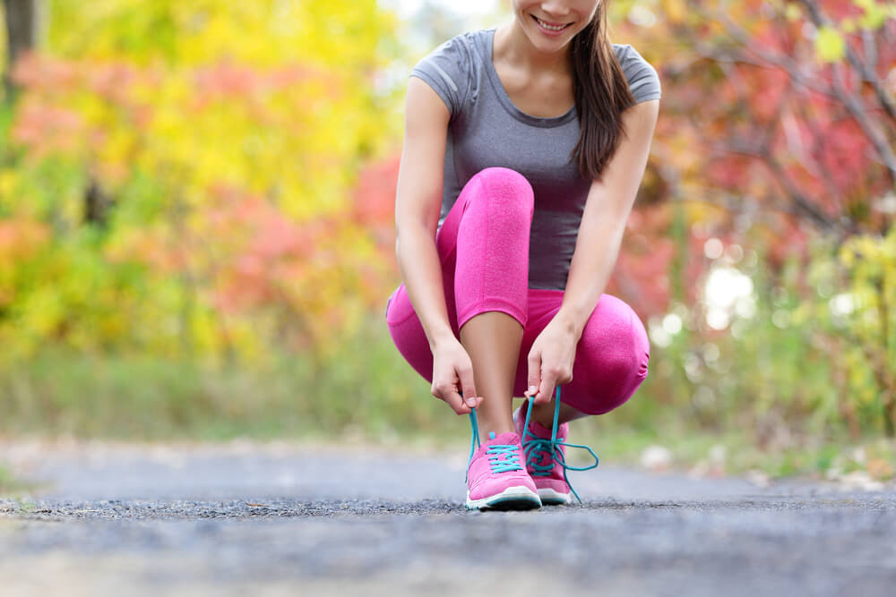 woman tying shoe