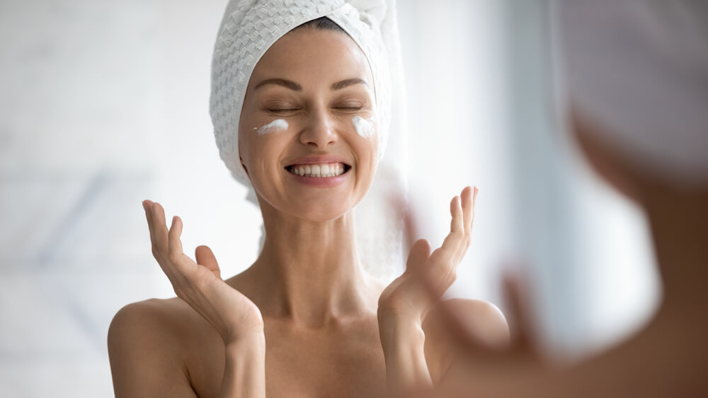 happy woman doing skincare