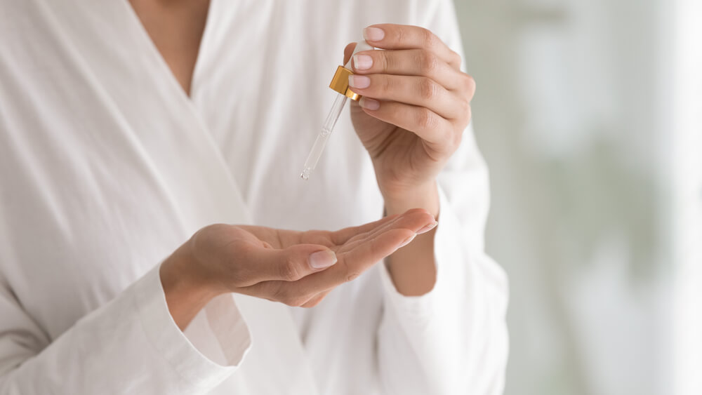 woman holding serum applicator