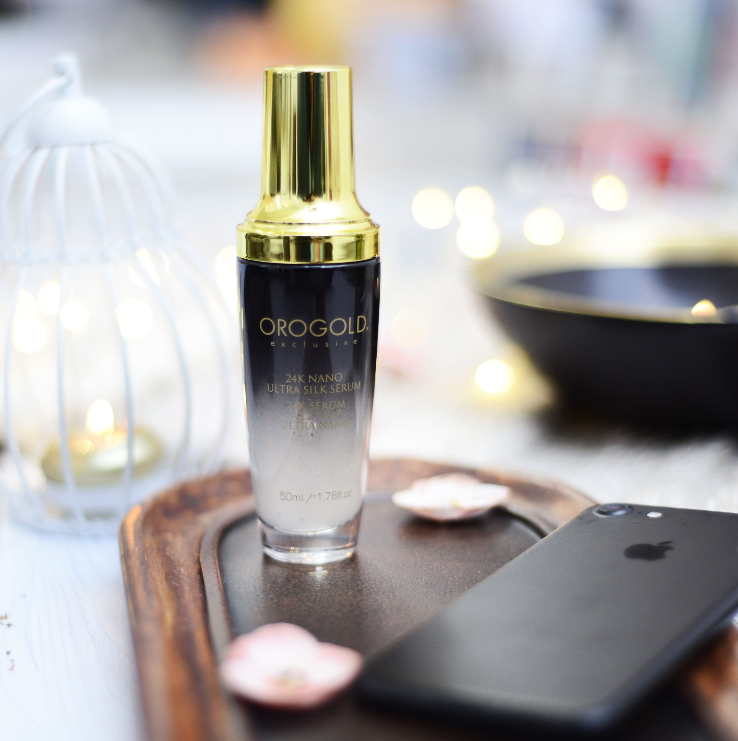 OROGOLD Nano Ultra Silk Serum bottle on table next to phone